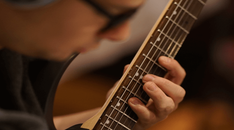 Take guitar lessons