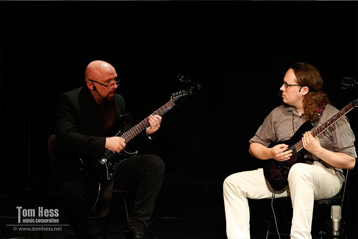 Tom Hess teaches a guitarist