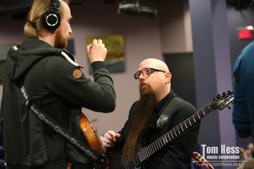 Guitar mentor Tom Hess talks with a student