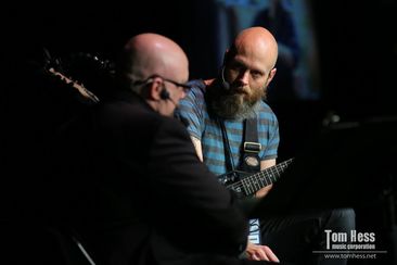 Tom Hess gives a guitar advice to his student